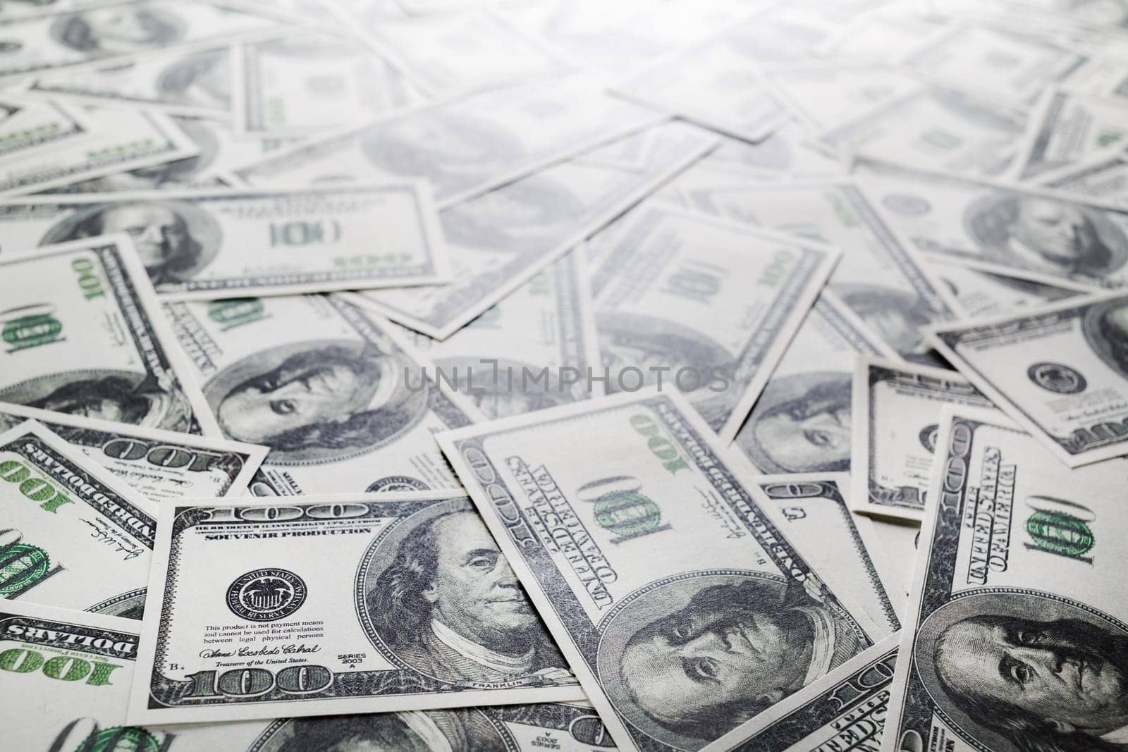 One hundred dollars pile. Money as background. Selective focus.