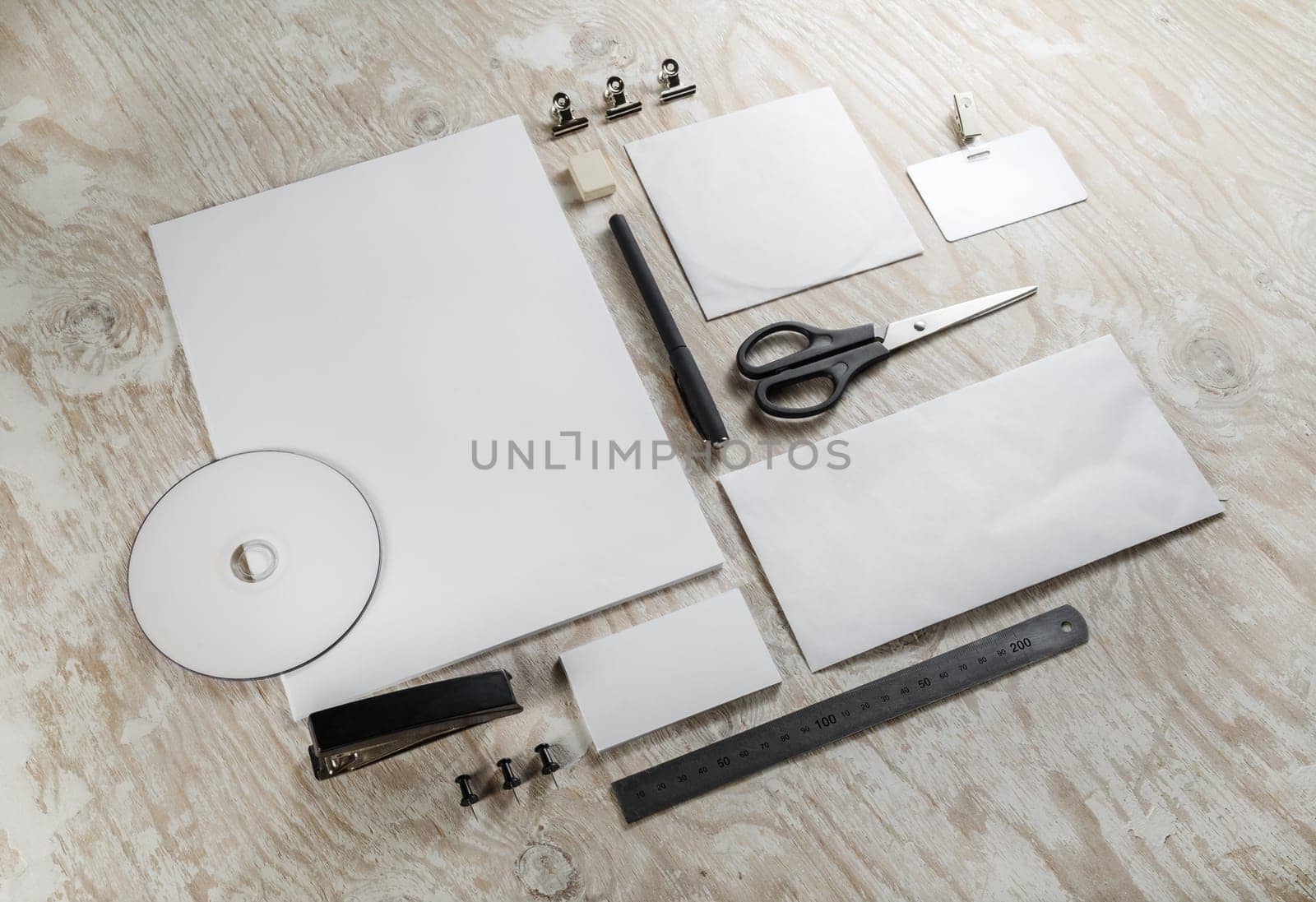 Corporate identity set on light wooden background. Blank template for design presentations and portfolios. Top view.