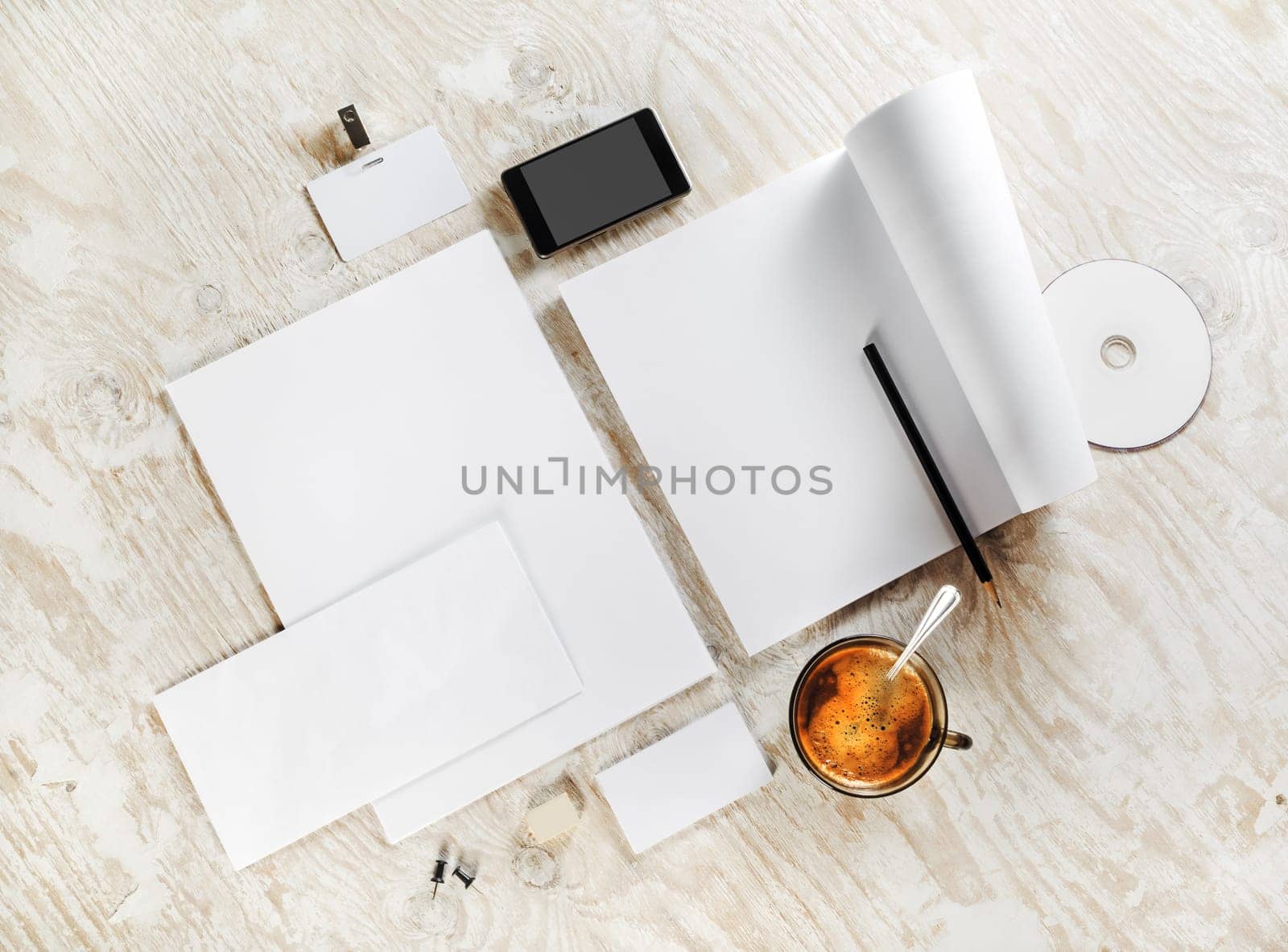 Photo of blank stationery. Corporate identity template on light wooden background. For design presentations and portfolios. Top view.