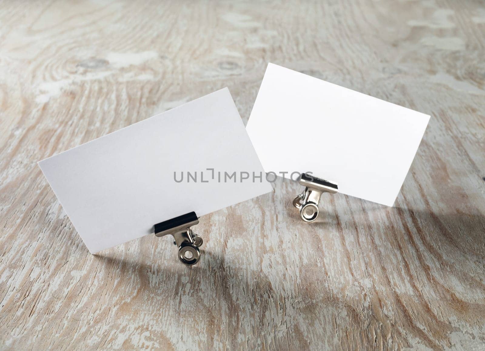 Blank business cards on light wooden background. Template for ID. Mock-up for branding identity.