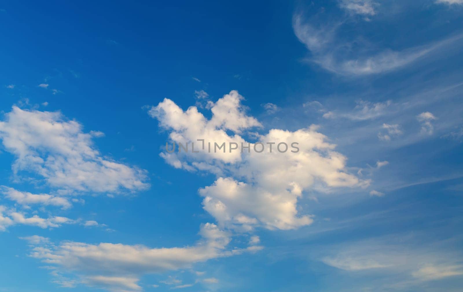Bright blue sky with white clouds on a clear sunny day.