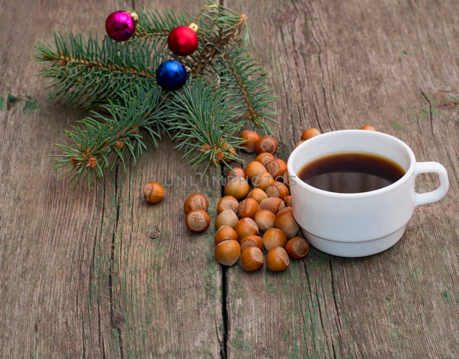 fir-tree branch, hazelnuts and a cup of coffee, a festive card, the subject Christmas and New Year