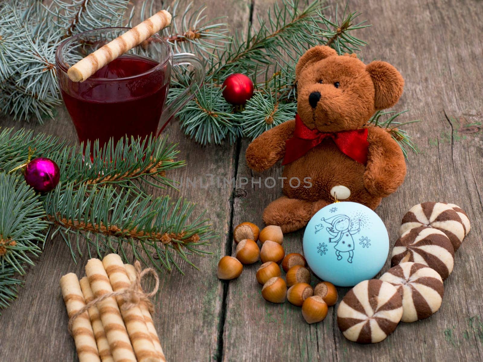three fir-tree branches, cup of tea, sweets and toy bear, still life, subject Christmas and New Year