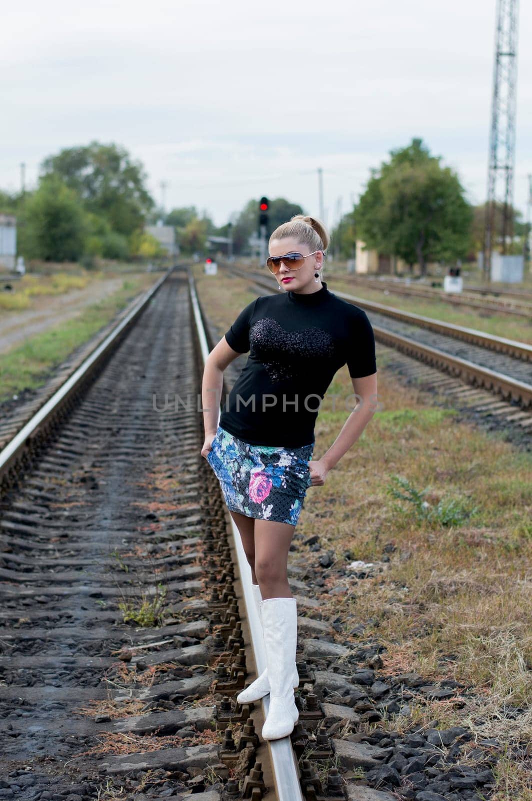 the sexy woman in white boots and sunglasses on rails, railway tracks, a subject beautiful women