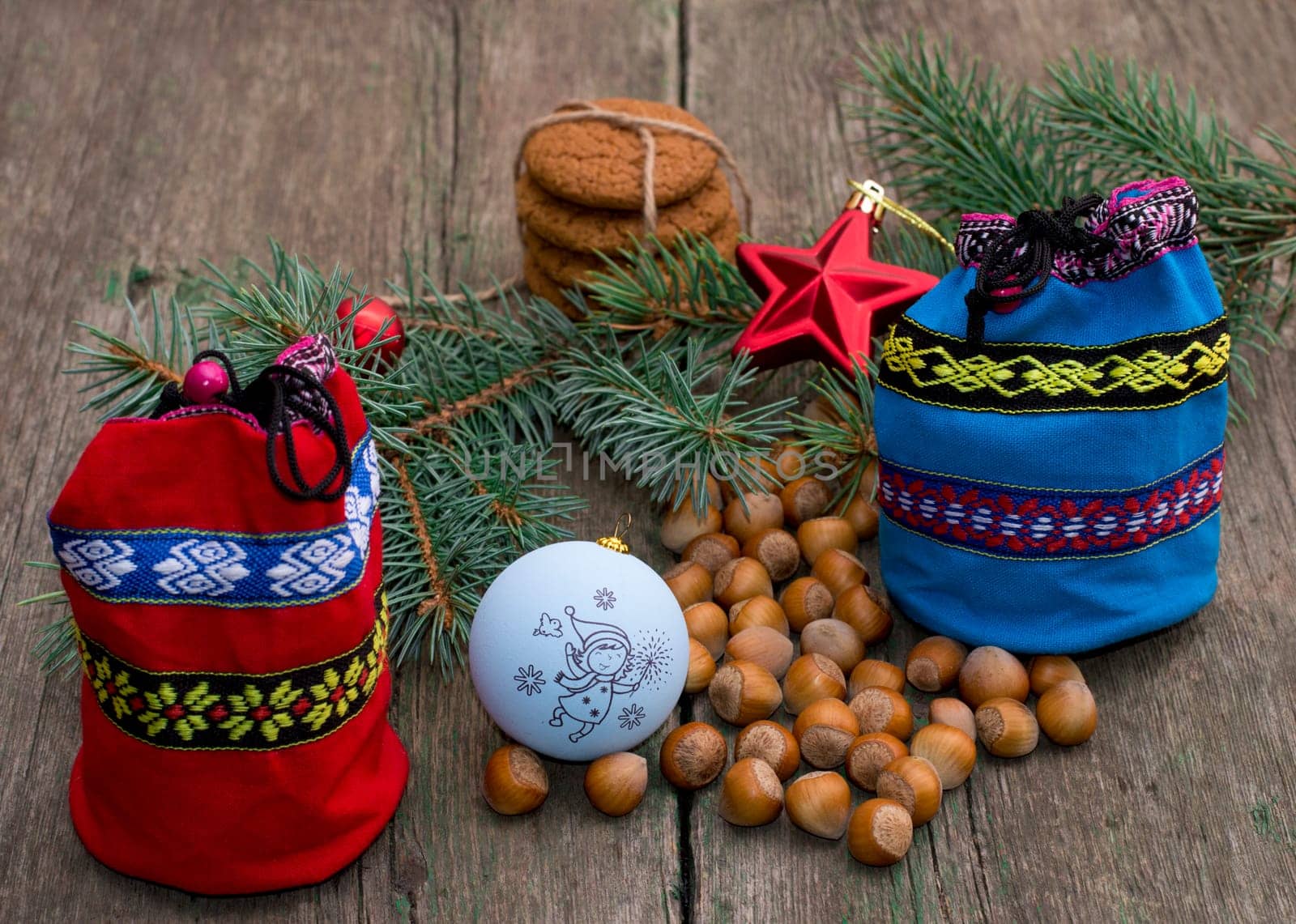 fir-tree branch, two bags of gifts, baking and hazelnuts, still life, subject Christmas and New Year
