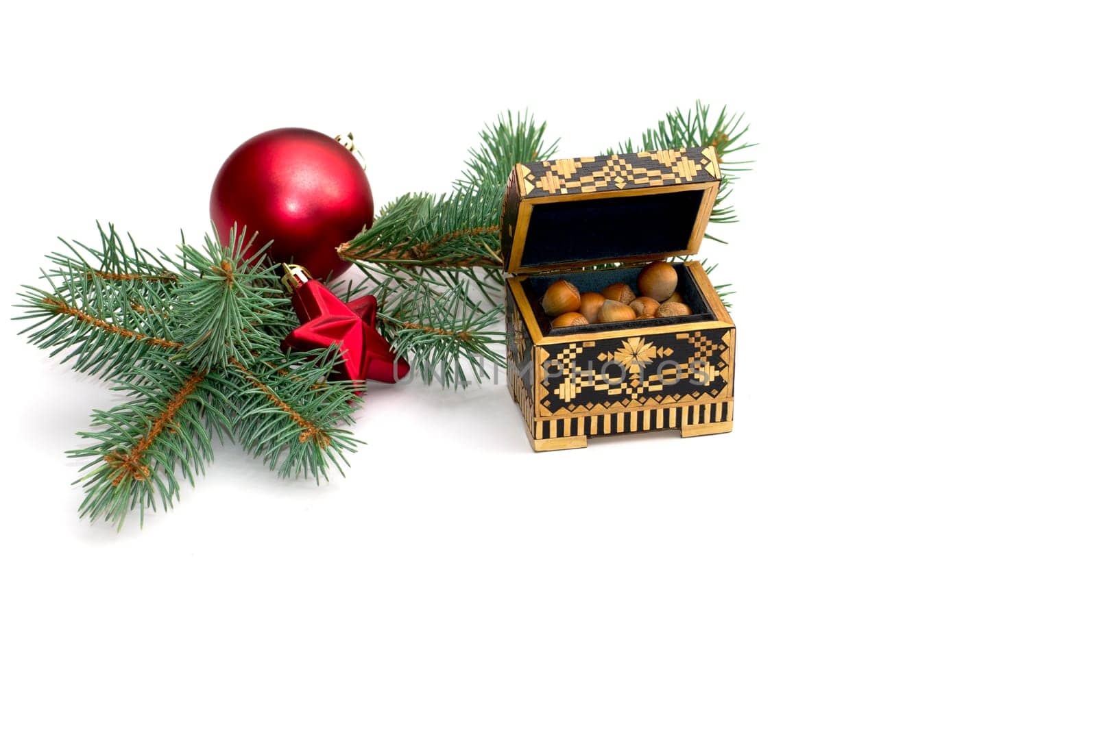 coniferous branch with New Year's scenery and an open casket with nuts, a still life, the subject Christmas and New Year