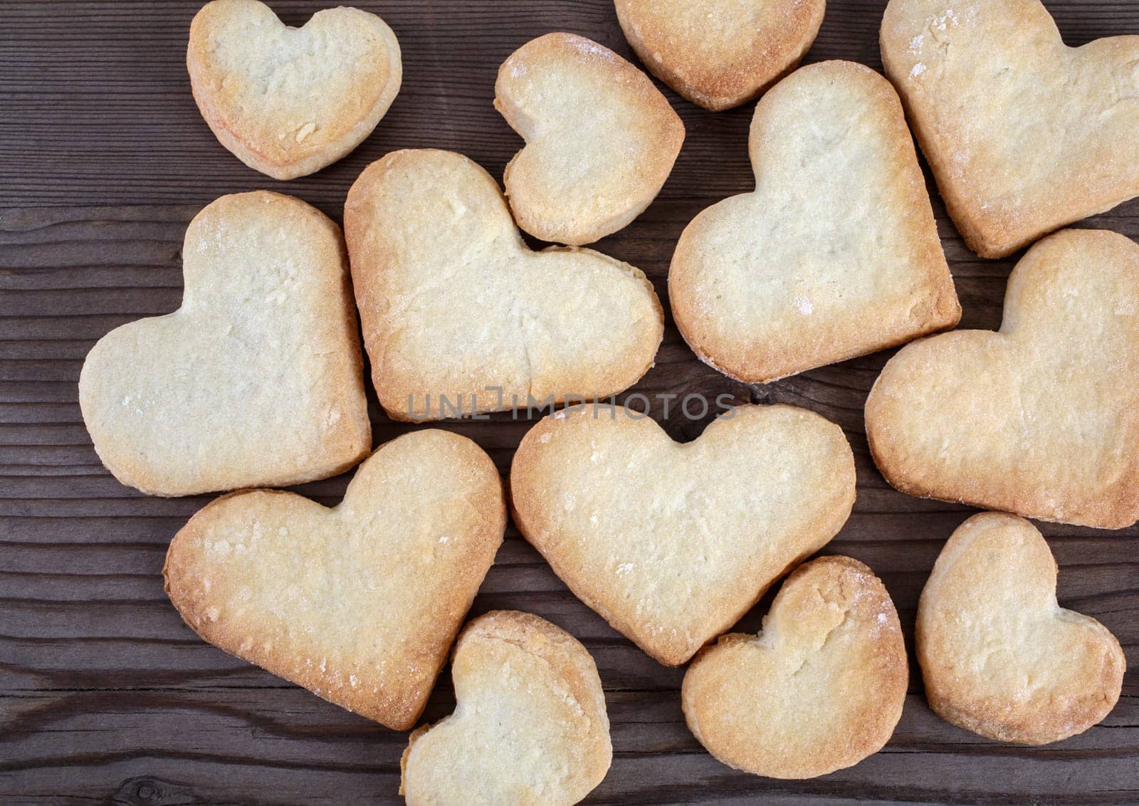 Heart shaped cookies on wooden background. Top view.