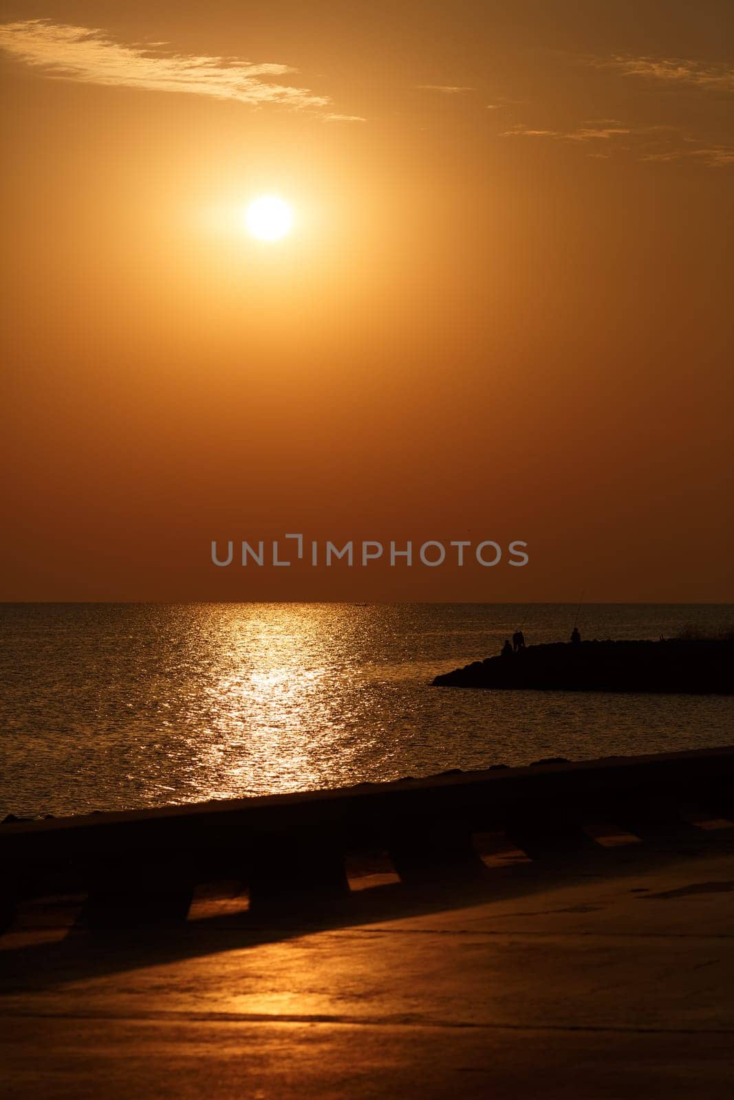 Orange sunrise over the sea. Vertical shot.