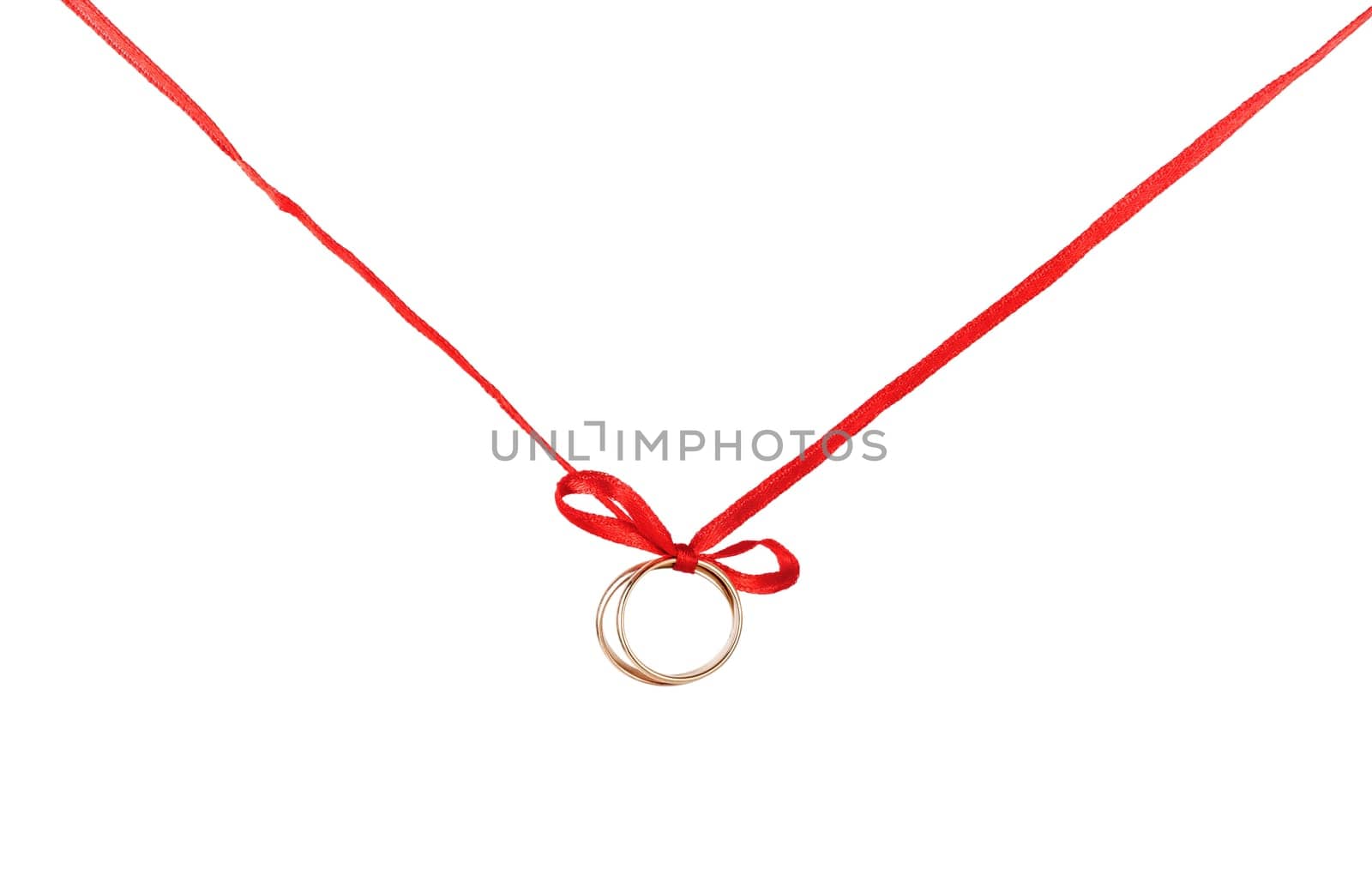 Wedding rings on a red ribbon with a bow. Isolated on white background.