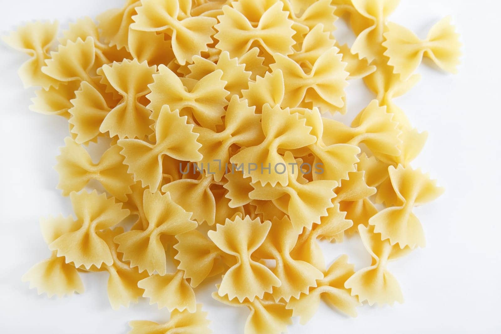 Uncooked italian bow tie pasta. Farfalle pasta.