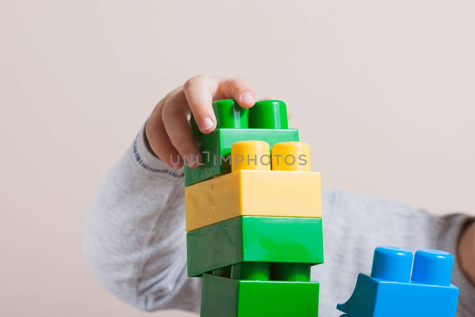 Playing little boy with colored cubes