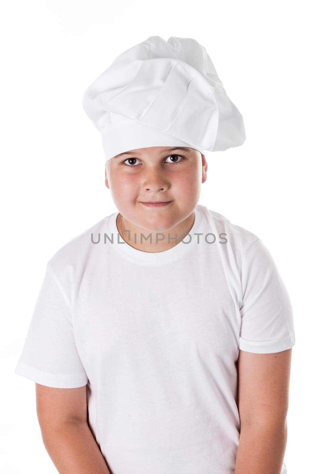 One little boy as chef cook making salad, cooking with vegetables. Isolated on white.
