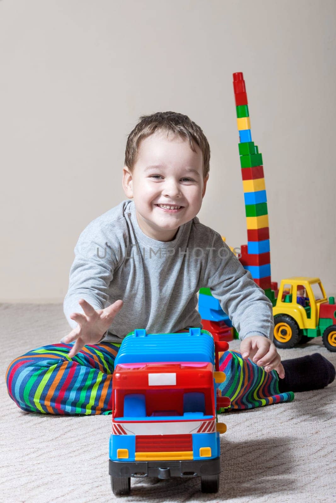 Playing little boy with colored cubes