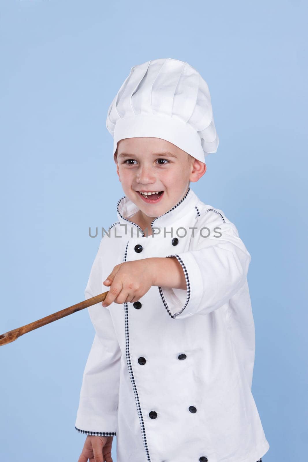 cheerful chef on a blue background with spoon