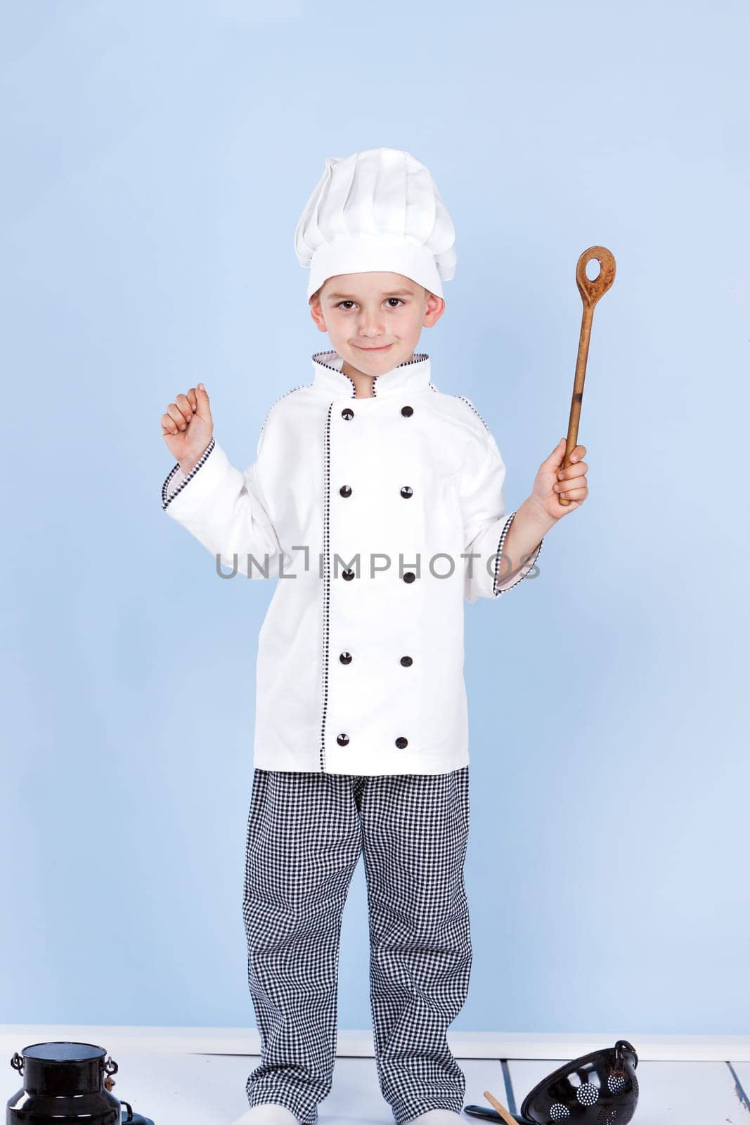 cheerful chef on a blue background with spoon