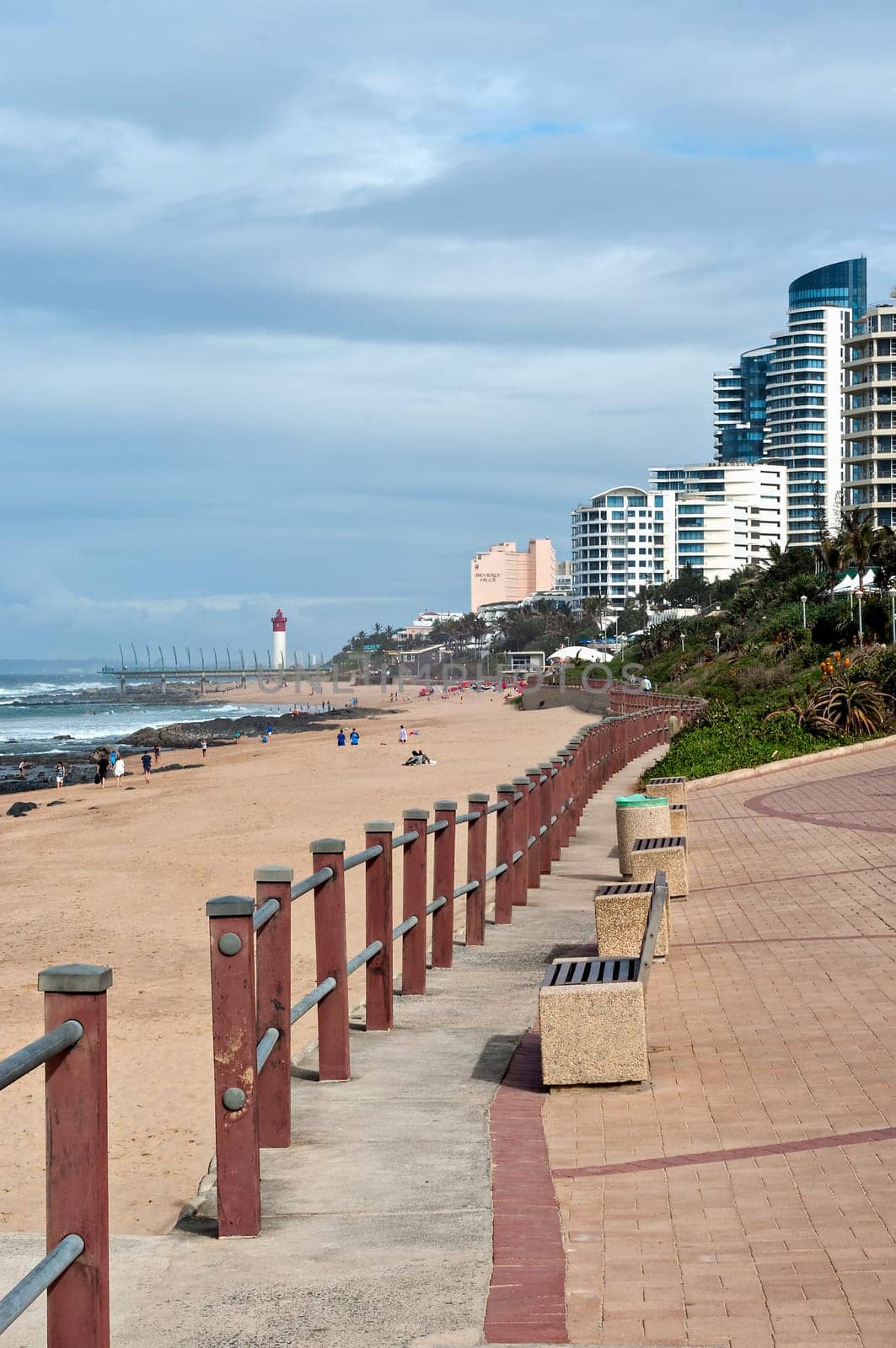 DURBAN, SOUTH AFRICA - JULY 09, 2016: Locals and tourists on the beach near the Millennium Pier and lighthouse in Umhlanga Rocks
