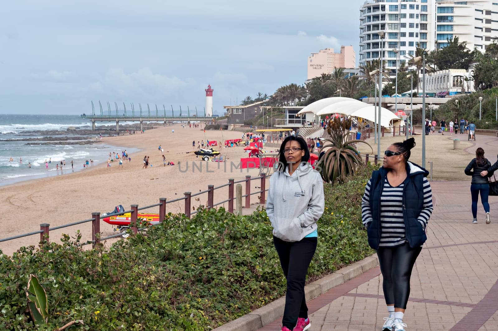 DURBAN, SOUTH AFRICA - JULY 09, 2016: Locals and tourists on the beach near the Millennium Pier and lighthouse in Umhlanga Rocks