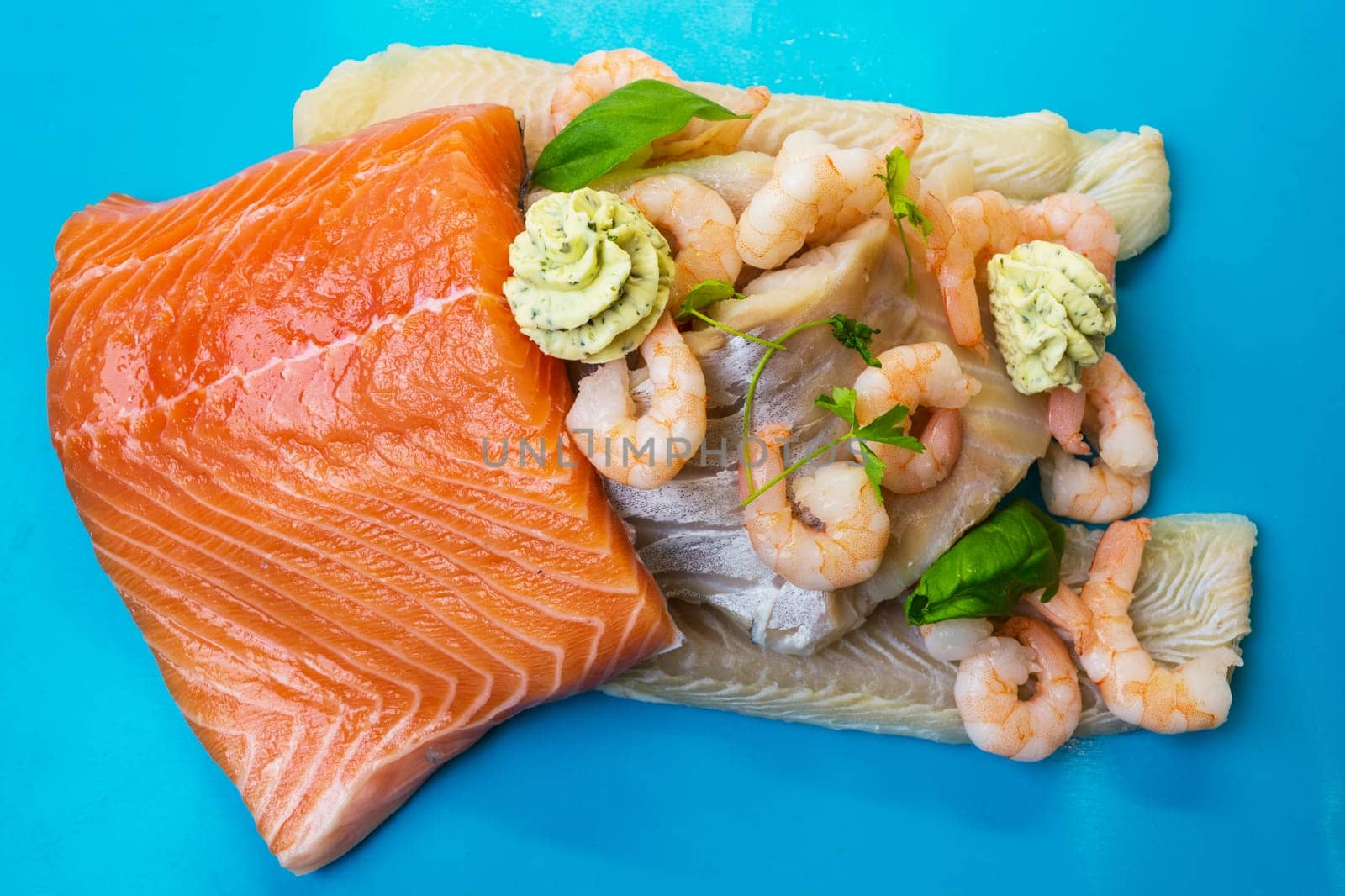 Various raw fish species as fillet such as salmon,cod and shrimp..