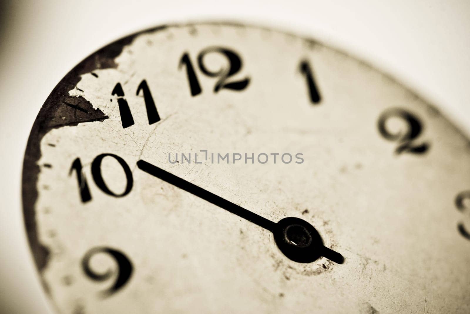 Horizontal close up of a clock dial showing ten o’clock