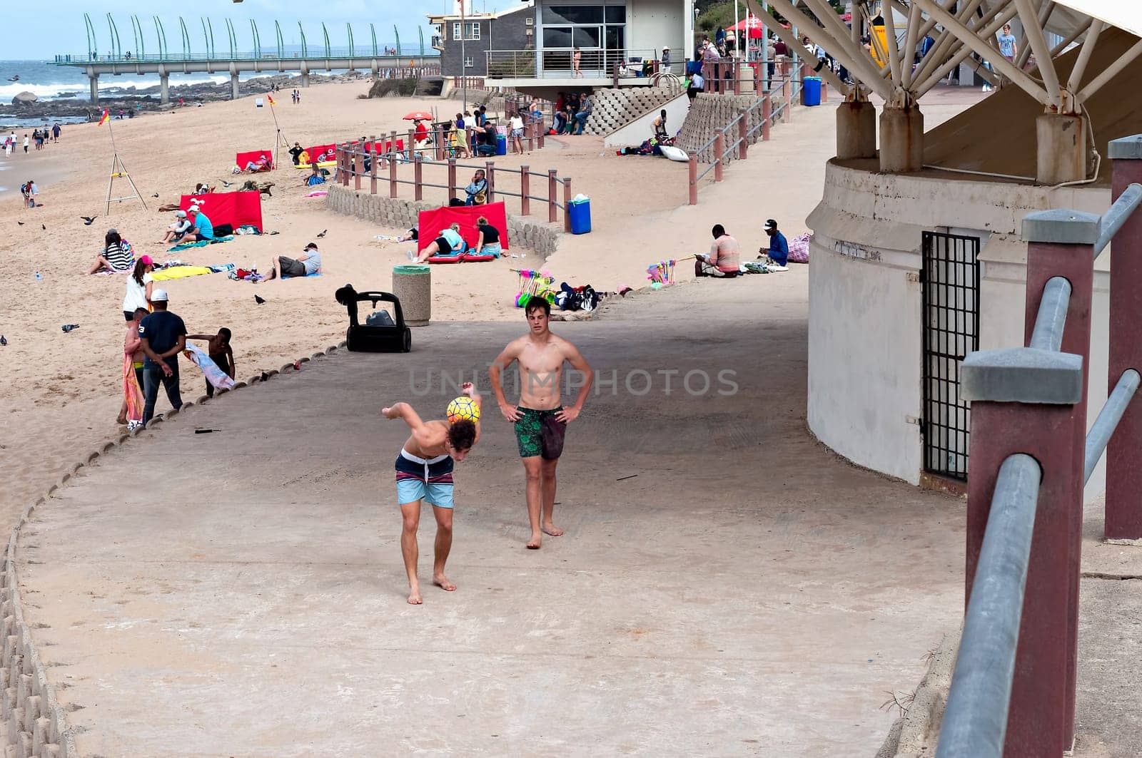 DURBAN, SOUTH AFRICA - JULY 09, 2016: Locals and tourists on the beach near the Millennium Pier and lighthouse in Umhlanga Rocks