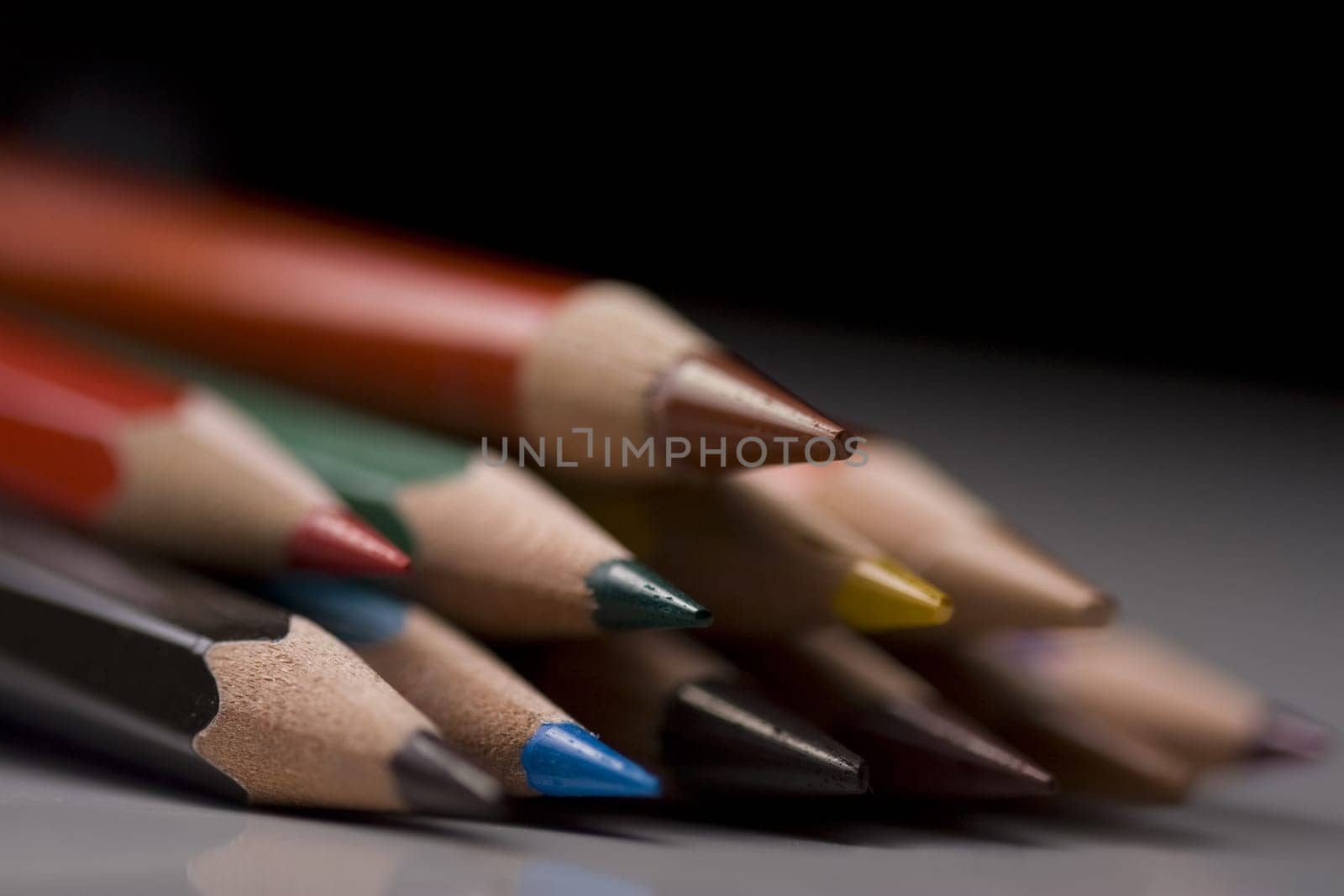 Group of colored pencils with shallow depth of field on black background