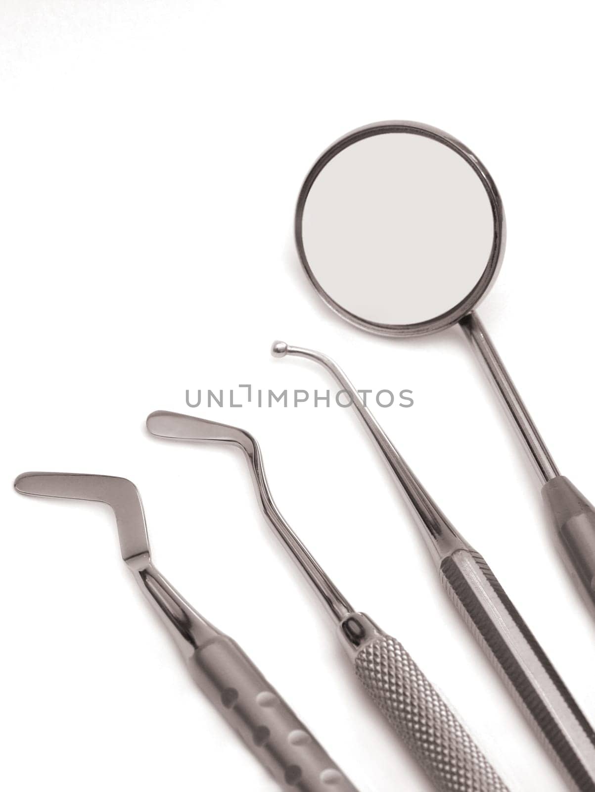 Set of chrome dental tools, viewed from the top isolated on white background