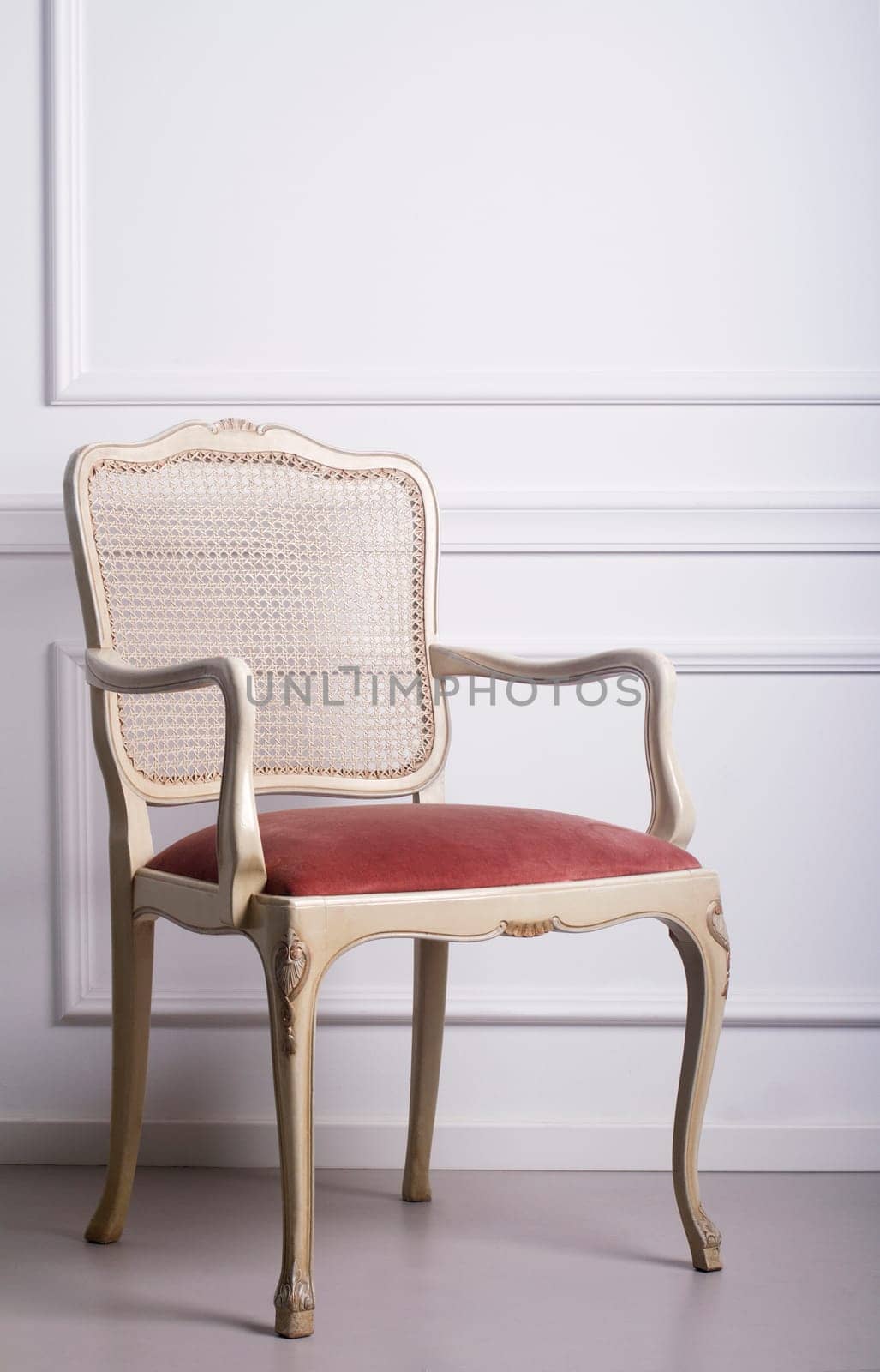 Vintage wooden chair against a white elegant interior wall