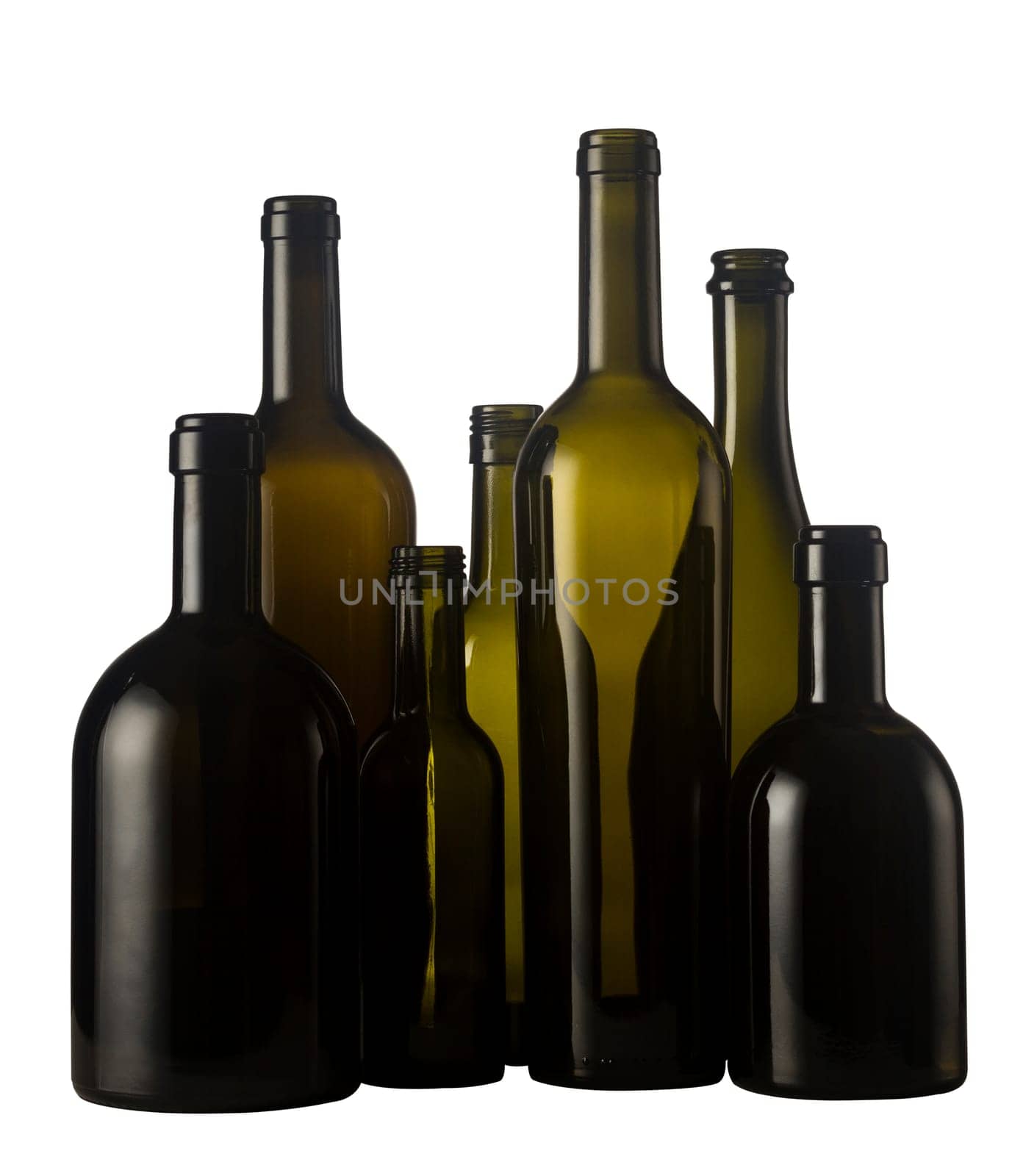 Horizontal front view of a group of empty wine bottles of different sizes, shapes and colorisolated on white background.