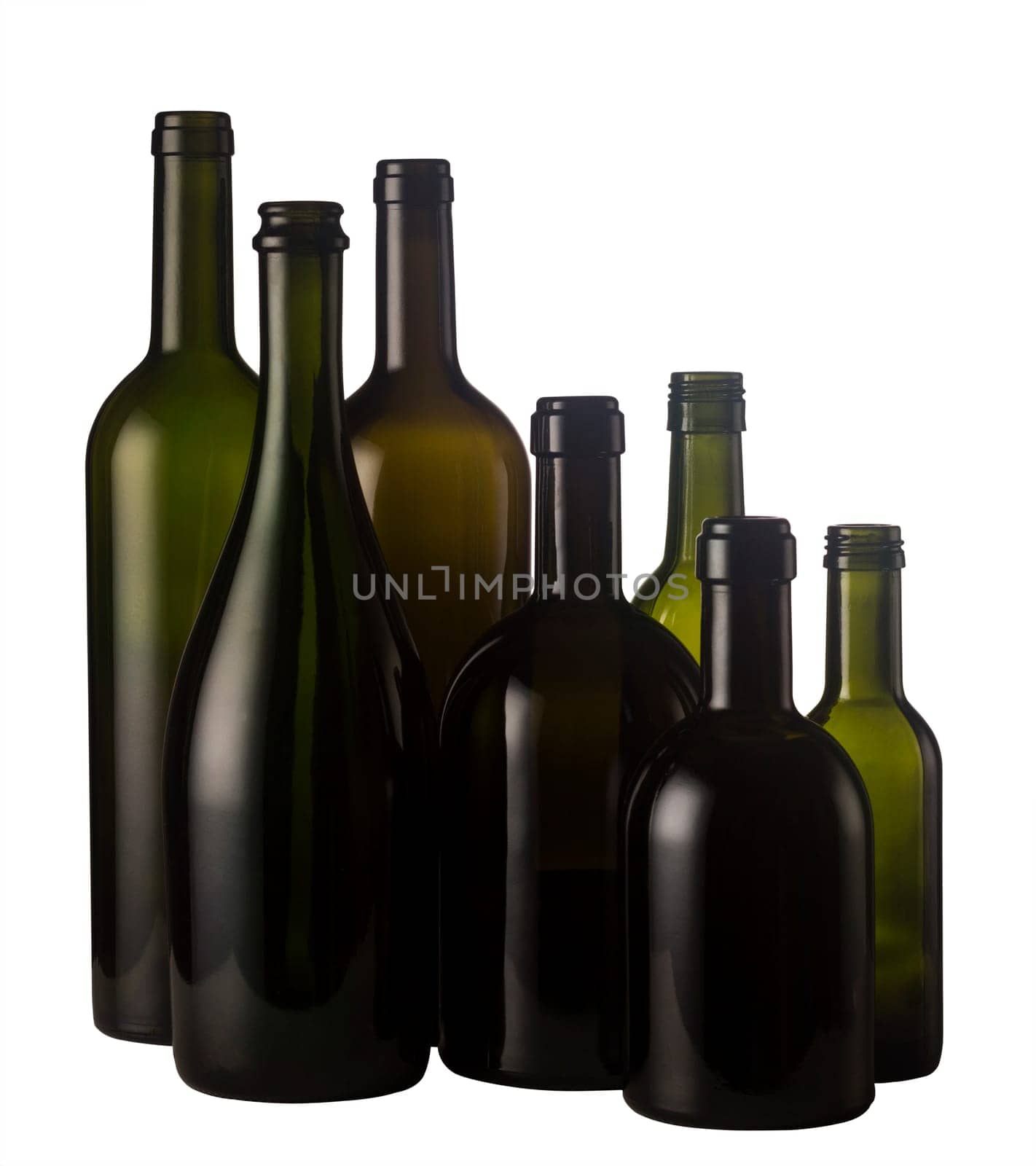 Horizontal front view of a group of empty wine bottles of different sizes, shapes and colorisolated on white background.