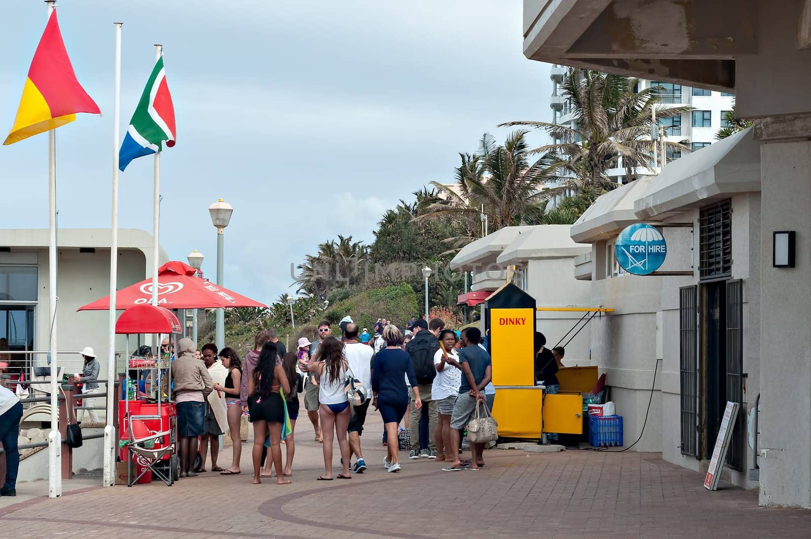 DURBAN, SOUTH AFRICA - JULY 09, 2016: Locals and tourists on the promenade near the Millennium Pier and lighthouse at Umhlanga Rocks beach