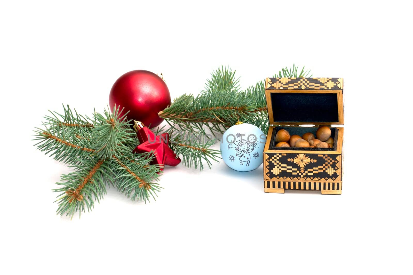 the fir-tree branch decorated with spheres and casket with forest nutlets, isolate, a subject holidays Christmas and New Year