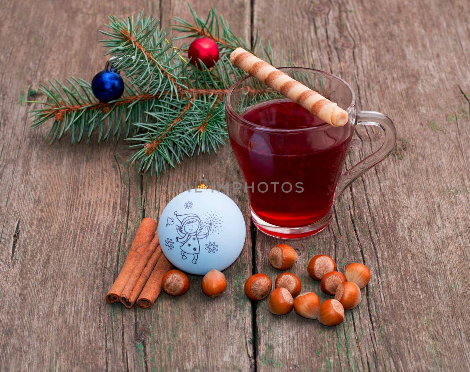 coniferous branch, tea, cinnamon and nutlets, still life subject Christmas and New Year