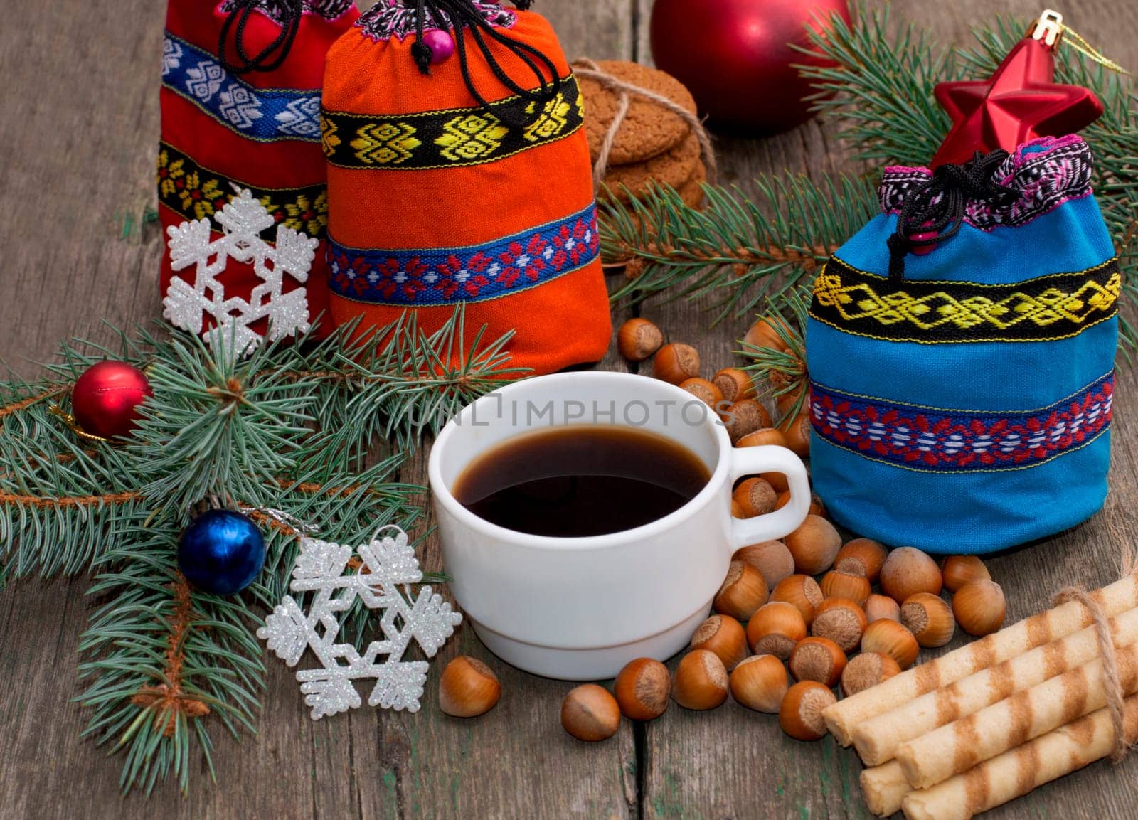 three gift bags, fir-tree branch, coffee and nutlets, subject Christmas and New Year