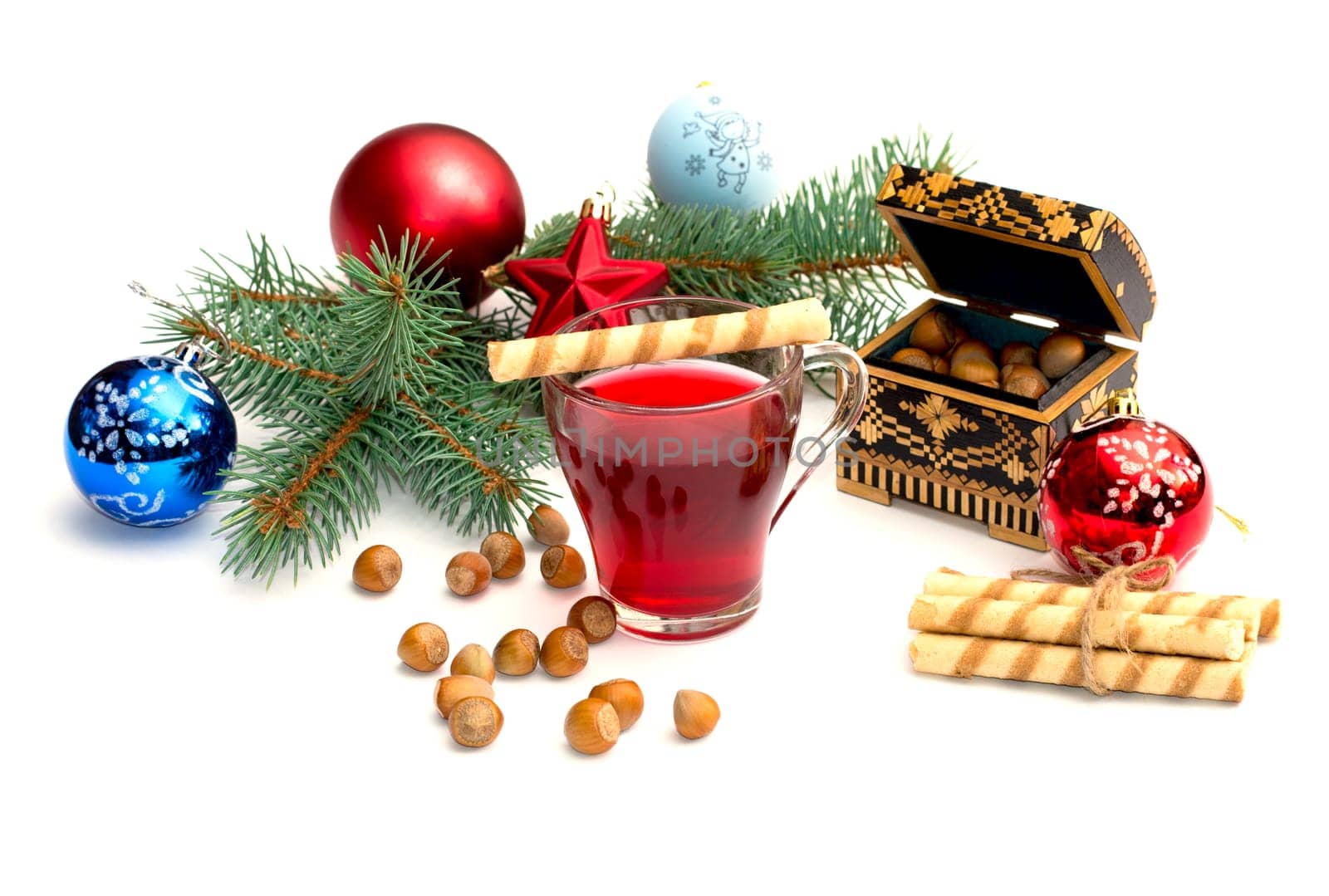 nutlets, tea and coniferous branch with Christmas tree decorations, a still life, the subject Christmas and New Year