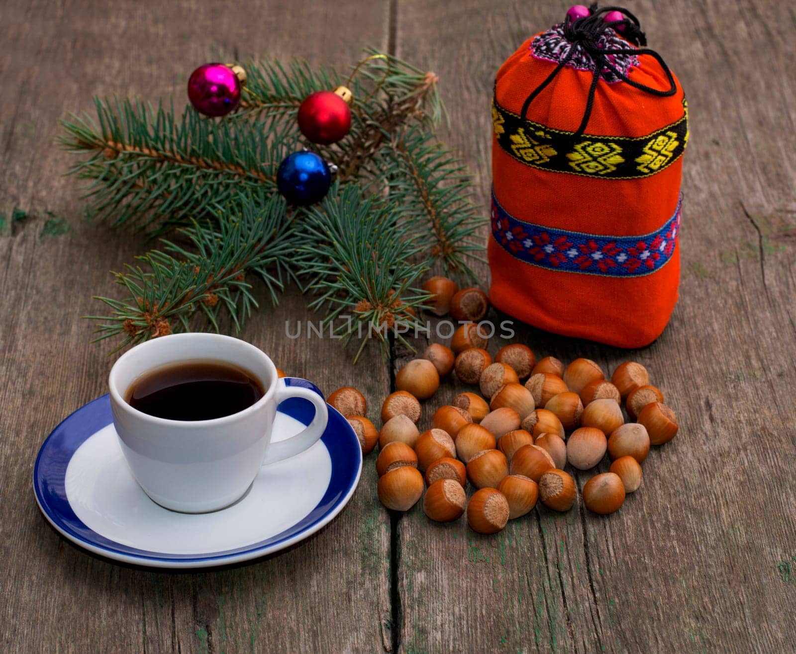 coniferous branch, coffee, orange gift bag and nutlets