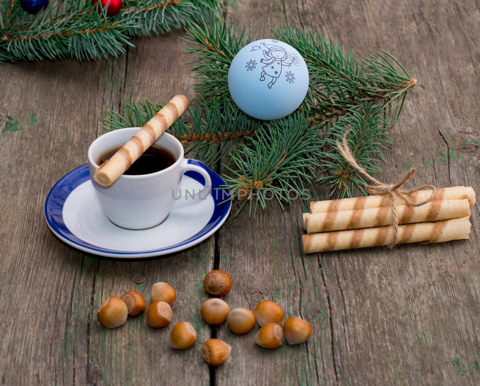 coffee, a fir-tree branch with Christmas tree decorations, nutlets, a subject holidays Christmas and New Year