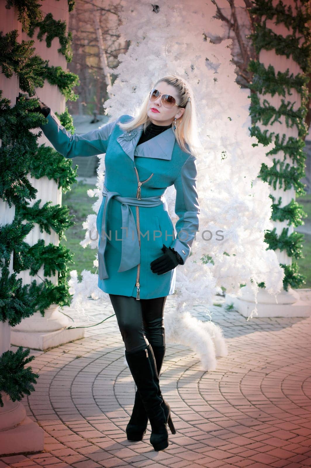 the beautiful woman near a white fir-tree and a column, the photo in the pink filter, a subject holidays Christmas and New year