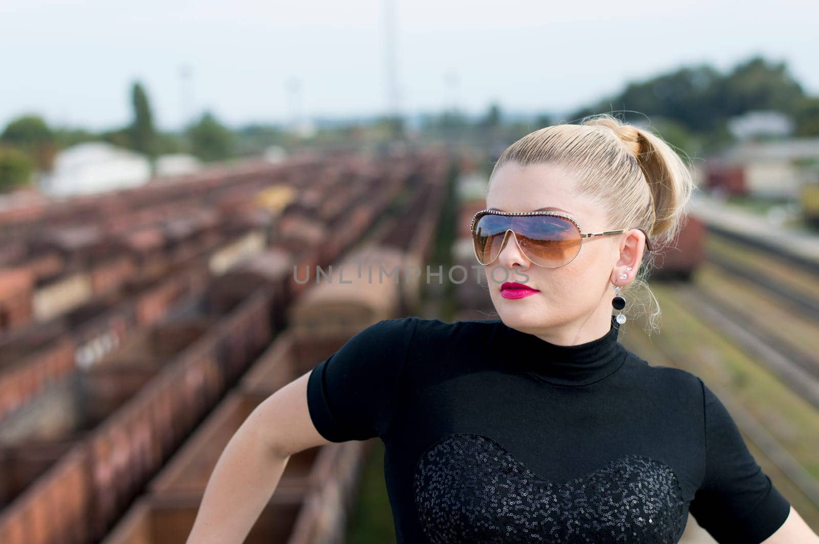 The woman's portrait on the bridge, over the railway station, a subject beautiful women and railway roads