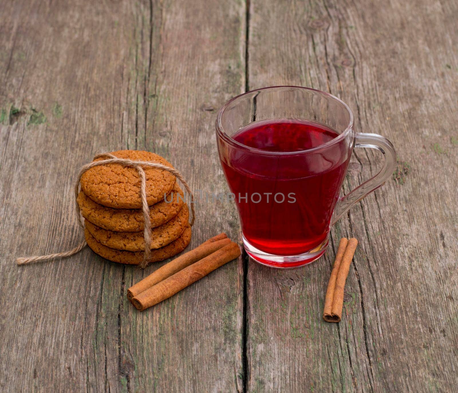 mug of red tea, cinnamon and linking of cookies, still life, on a wooden table, a subject drinks and sweets