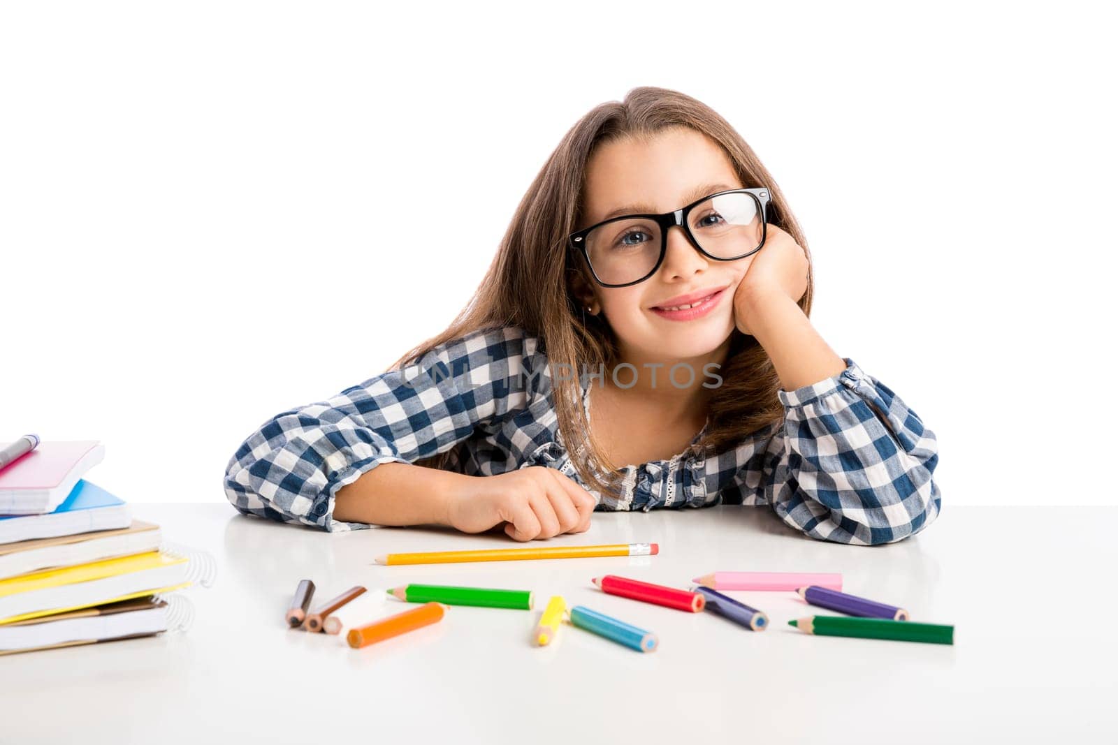 Little girl at school making drawings and painting