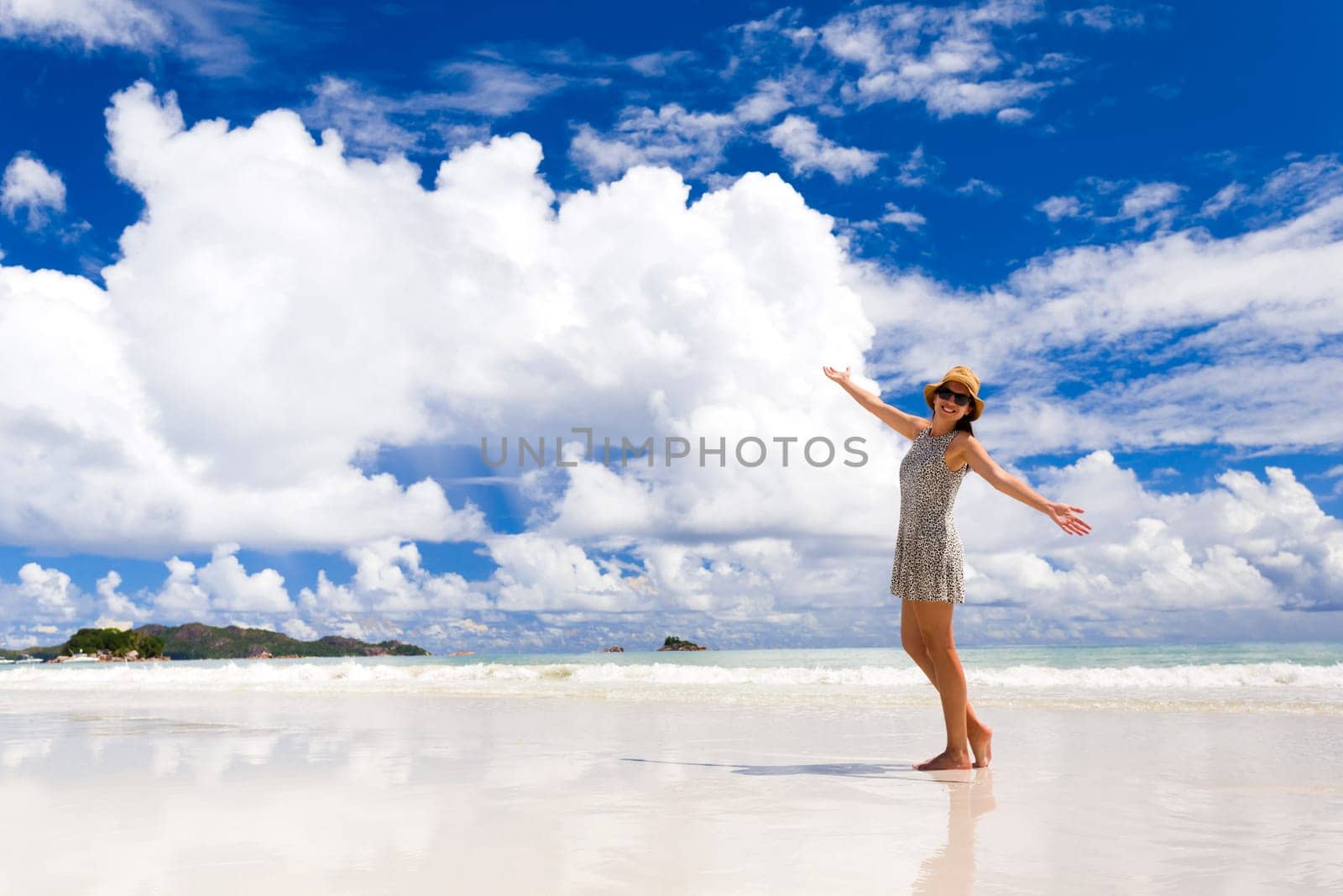 Beautiful woman walking in the beautiful beach of Praslin, Seychelles