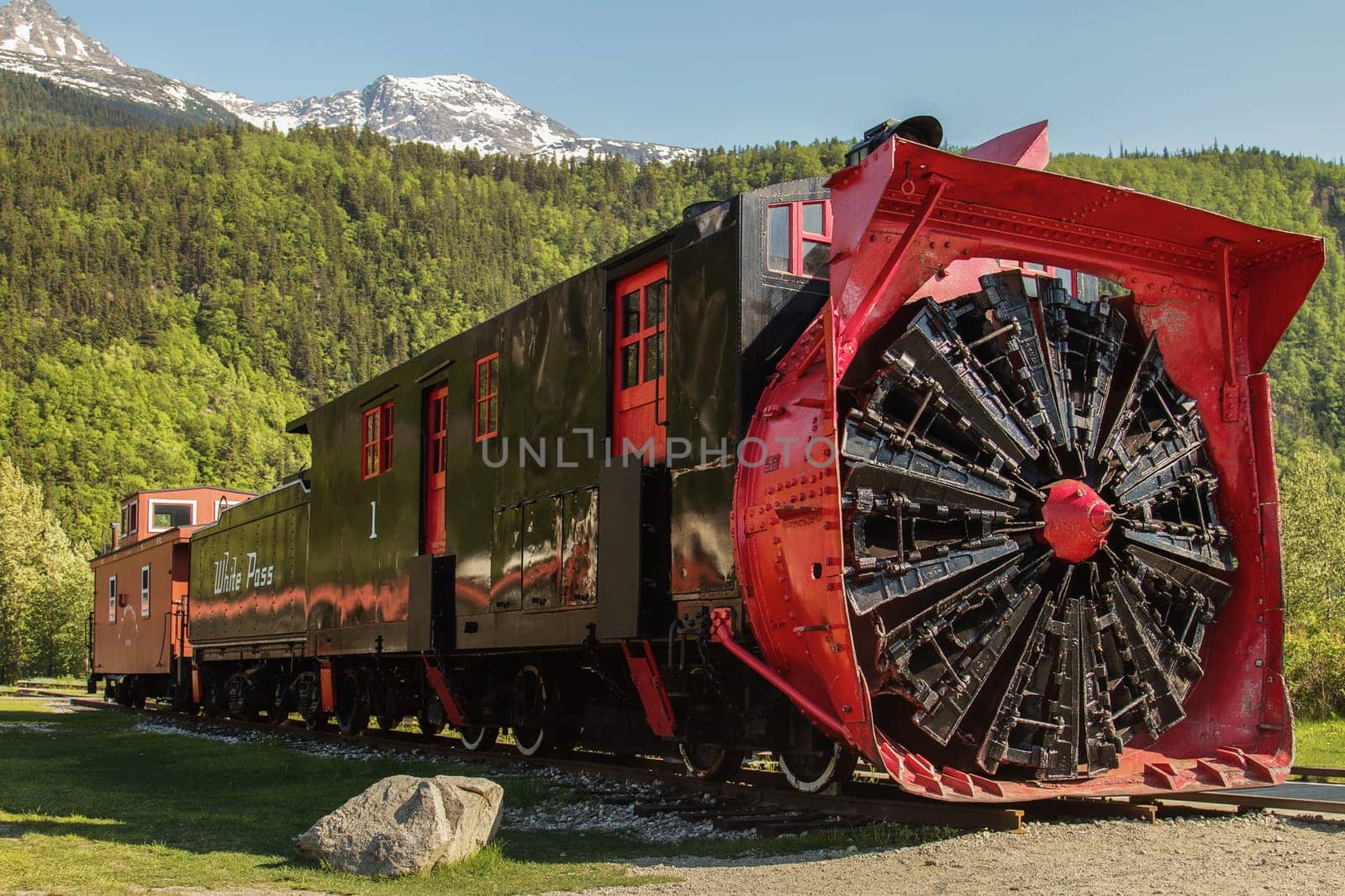 SKAGWAY, ALASKA, USA - MAY 31, 2011: Old Snow Blower Train and Trees in the Background