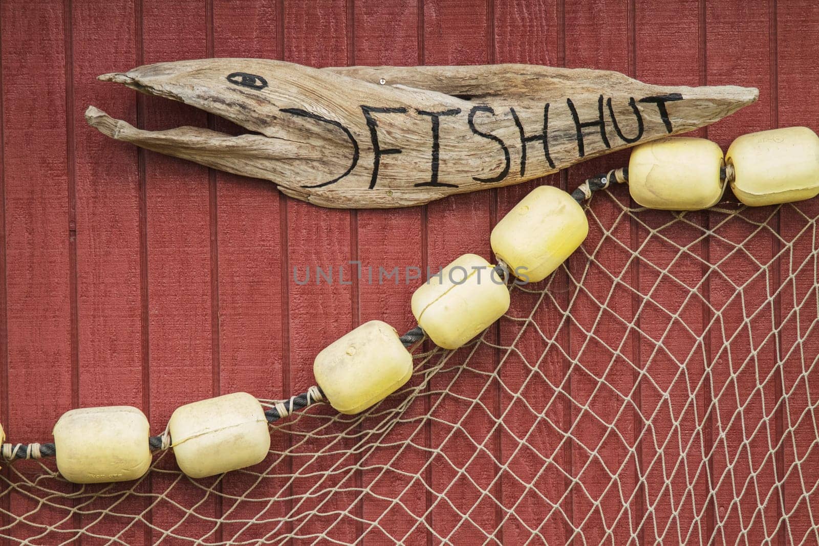 Wooden Carved Sign with Net on House of Fisherman in Icy Strait Alaska