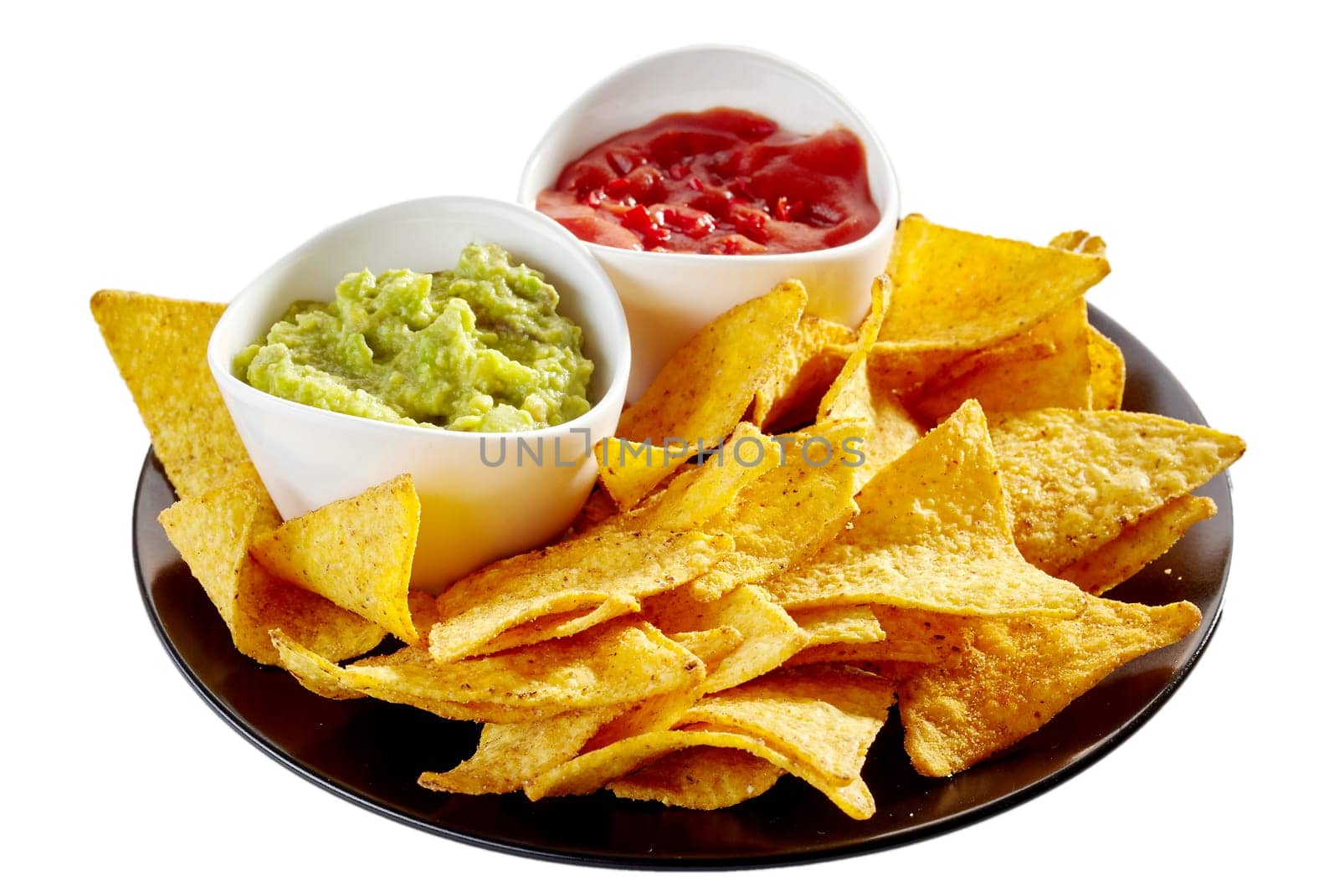Round isolated plate of delicious nachos, salsa and guacamole over white background