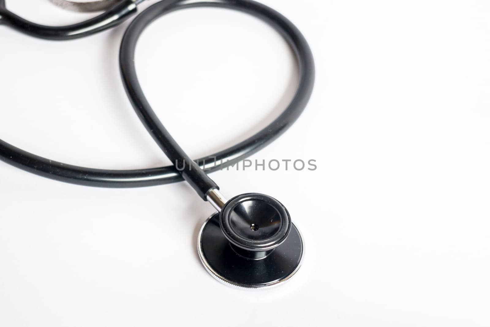 Black stethoscope on white background, stock photo