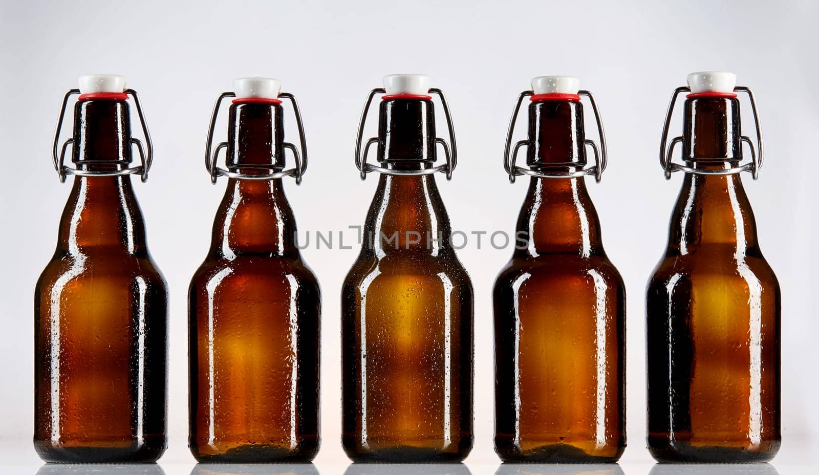 Straight on view of five blank glass bottles of beer for Oktoberfest or other concept regarding alcohol sales and branding