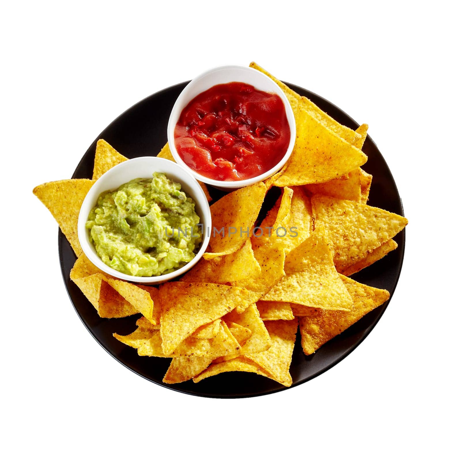 Top down view on round isolated plate of nachos, salsa and guacamole over white background