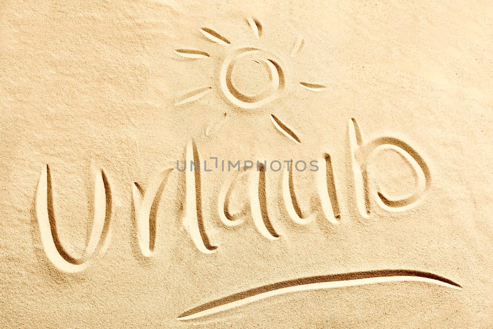 Urlaub German text with shining sun sketched on golden beach sand conceptual of coastal and tropical summer vacations at the seaside