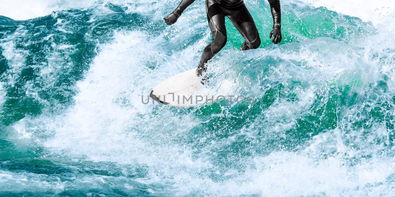 Surfing on turquoise ocean wave with close-up water splashes