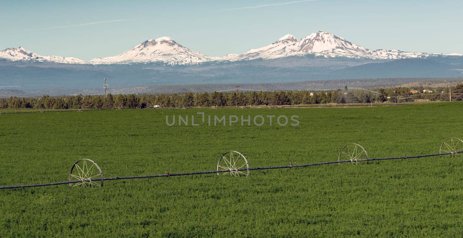 Farm irrigation tools stand in the farm fields near Three Sisters and Bend, Oregon